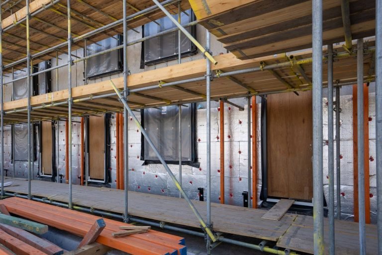 Exterior insulation being applied to a building envelope