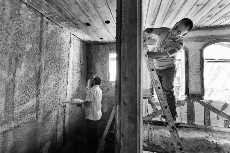 Insulation contractor reviewing project plans with a homeowner